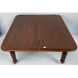 A Victorian mahogany extending dining table, with additional leaf, raised on reeded supports to