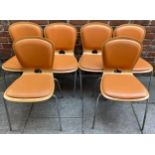 A set of six bent plywood stacking chairs by RDS AKABA, each with stuffed orange seats and back