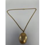 An 18ct gold belcher-link necklace with unmarked gold oval hinged locket with engraved foliate