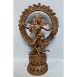 A 20th century Indian copper alloy figure of the God Shiva, modelled standing atop another figure,