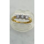 An 18ct yellow gold three stone diamond ring, set with three round brilliant cut diamonds in a