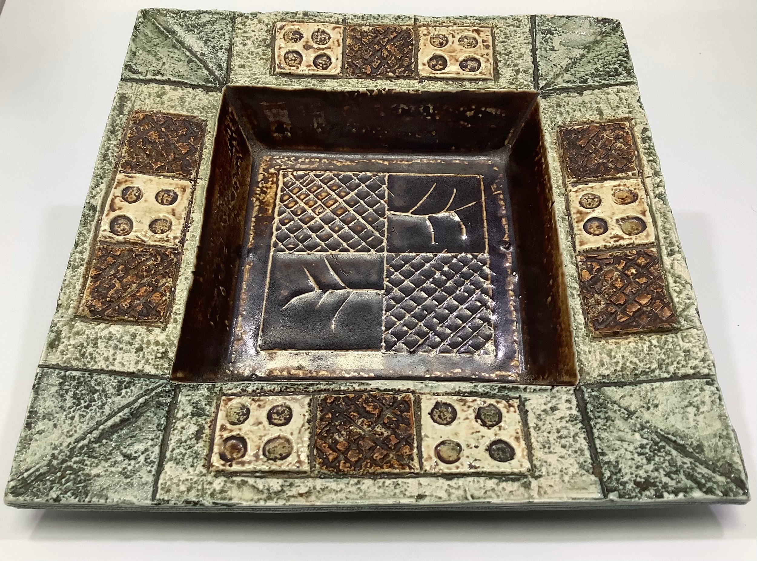A Troika Pottery dish/ashtray of squared form decorated by Louise Jinks, with incised and painted
