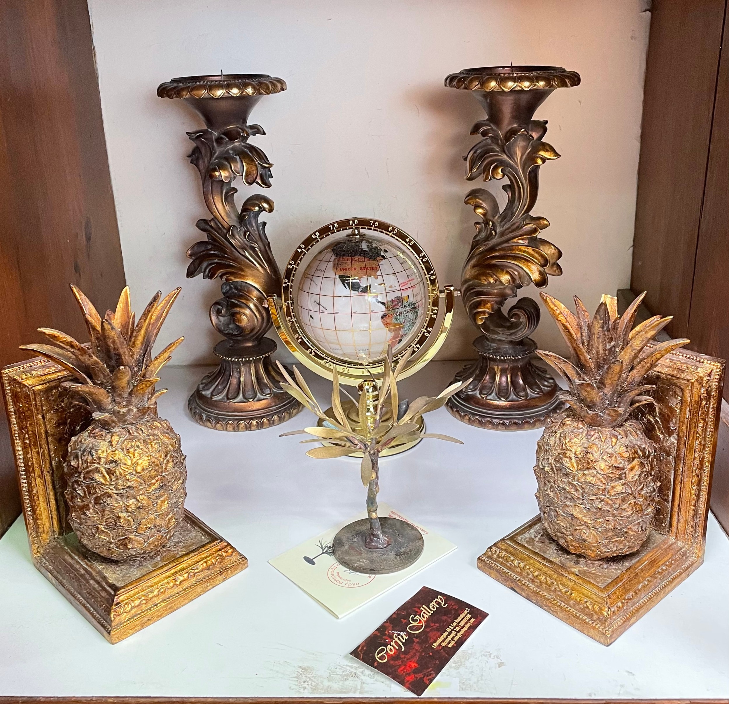 A pair of gilt painted composite pineapple bookends (one af), together with a pair of foliate carved