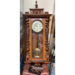 A walnut cased eight-day Vienna wall clock with cream painted dial, interspersed red fleur-de-lis