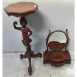 A carved wooden blackamoor style jardiniere stand, with young man holding aloft a bunch of grapes,