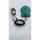 Three silver brooches, one styled as a peacock, one a marcasite set cuckoo clock watch, and one an