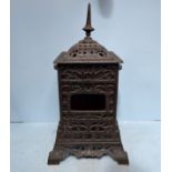 A Rippingilles Patent cast iron stove with red glass panels, twin handles and opposing open sides,