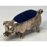 A silver pin cushion modelled as a pig with curled tail, stamped ‘925’, approximately 4cm long