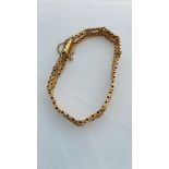 A 15ct yellow gold gate bracelet, with safety chain, weighing 11.8 grams.