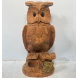 A carved wooden owl tobacco jar with glass eyes, space for matches and vesta case rest, 36cm high