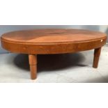 An oak veneered coffee table, of oval form, in two halves with fastenings to underside, beaded top