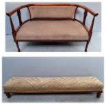 An Edwardian parlour sofa, with curved back, beige upholstered stuff-over seat and back, raised on