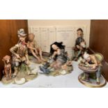 Five various Capodimonte porcelain figure groups including a Watchmaker, an Organ Grinder with a