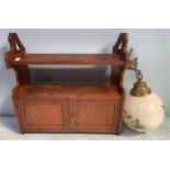 A small stained mahogany wall hanging cupboard with shelf above, 60cm wide, together with a white