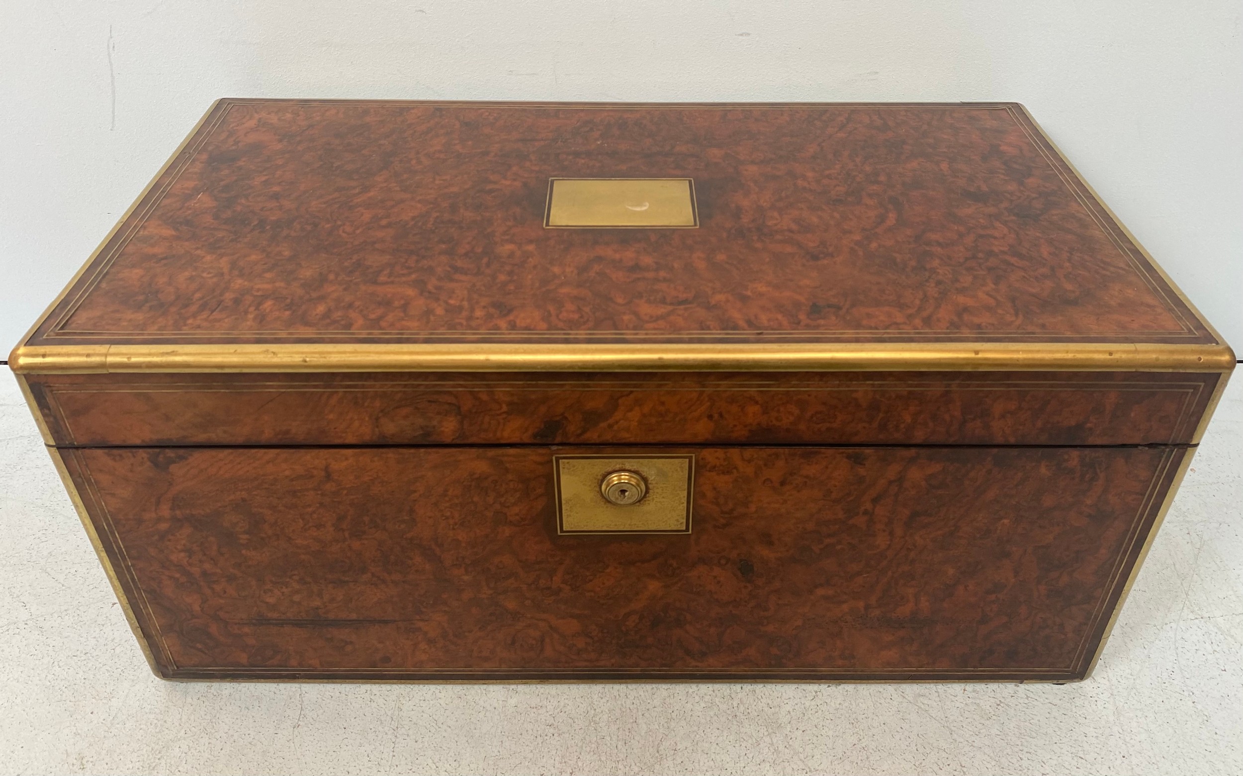 A large Victorian burr walnut writing slope, with brass bound edges and twin flush handles, side