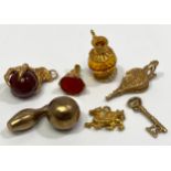 Five various 9ct gold charms including a dragon claw holding a ball, bowling ball and pin, 21 Key,