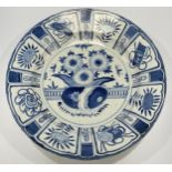 A large Chinese porcelain 'Kraak ware' dish, painted in underglaze blue and typically radially