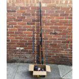 Three various split cane fishing rods together with some fishing reels and lines etc.