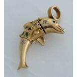 A 9ct gold dolphin articulated pendant, set with various coloured stones to the body, and blue