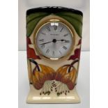 A Moorcroft Pottery mantel clock, in the Anna Lily pattern, of rectangular form, the white enamel