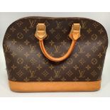 A ladies Louis Vuitton Alma handbag, in the brown monogram coated canvas design, with light tan