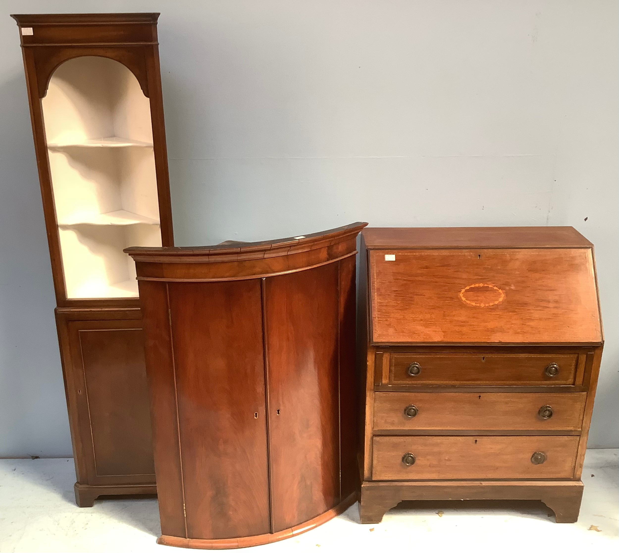 An Edwardian mahogany bureau with sloped front, three graduated inlaid drawers, together with a 19th