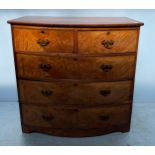 A 19th century mahogany bow-front chest of two short and three long flamed graduated drawers with