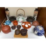 A collection of various teapots including Chinese Yixing, French Limoges with wicker handle, two