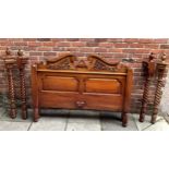 A late 20th century stained and carved walnut four-poster bed, complete with side rails, slats,