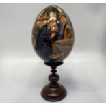 A St Petersburg hand-painted and laquered papier-mache egg depicting the Adoration of the Magi,