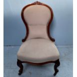 A Victorian stained walnut spoon-back nursing chair with stuff-over upholstery