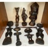 A quantity of ethnic carved figures including African fertility statues, a steel bladed knife and