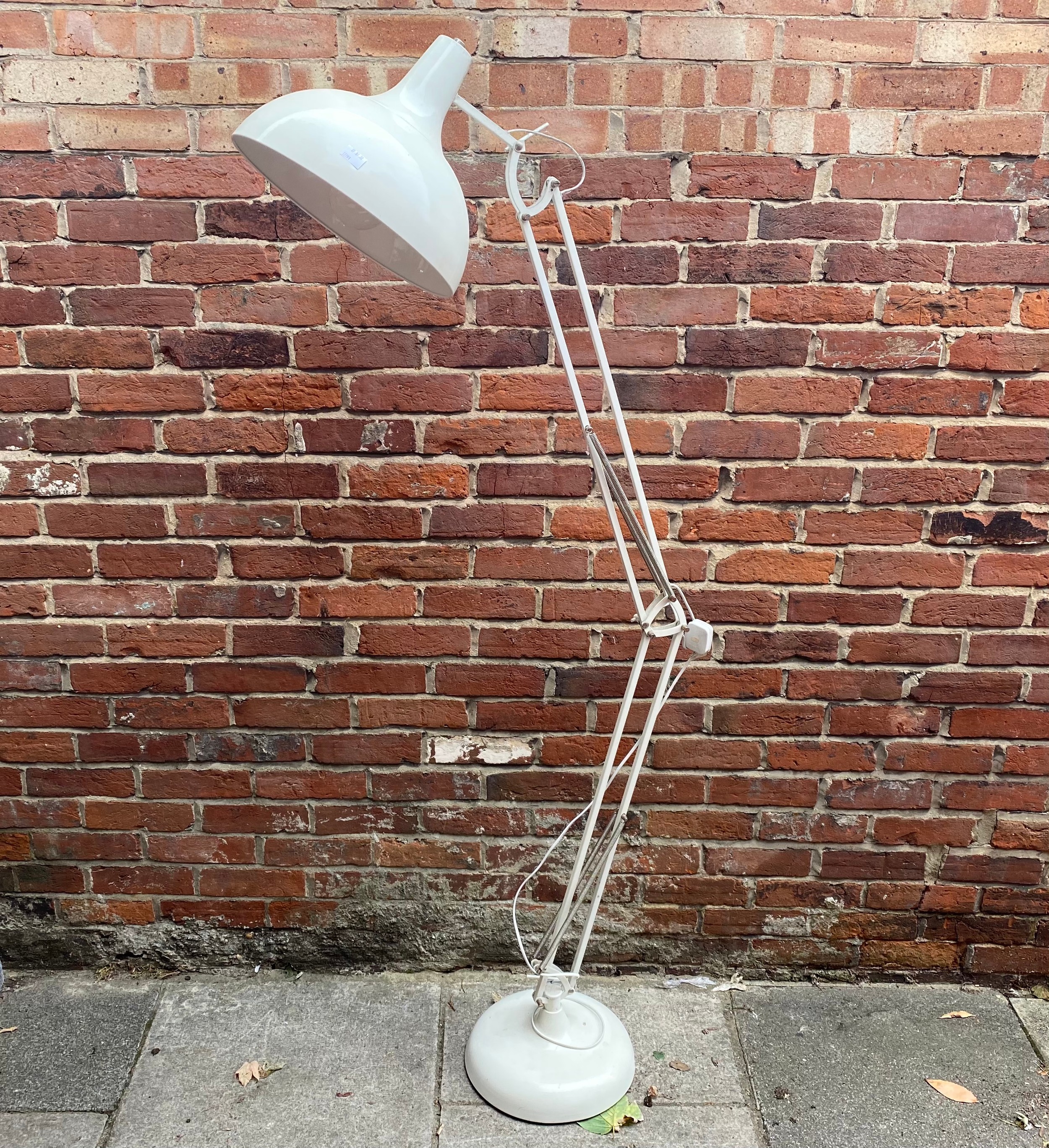 A floor standing white metal Anglepoise style lamp raised on circular base, approx. 200cm high
