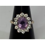 A 9ct gold, amethyst and diamond dress ring, oval faceted amethyst measuring approximately 10x8mm,