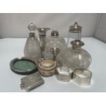 A small collection of assorted silver items including a loaded squat candlestick, a vesta case,