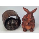 A boxwood netsuke carved rabbit eating a leaf, signature to base, together with an okimono carved as