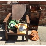 Two vintage telephones in yellow and green, together with a Decatur Industries pipe stand and a wall