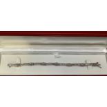 A 14ct white gold and diamond tennis bracelet, set with multiple baguette and tapered baguette