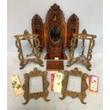 Two pairs of figural brass easel photo frames, 30cm high, together with a Dutch wooden fold out