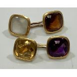 A pair of yellow metal cufflinks, (testing as 18ct or above), each set with a cushion-cabochon cut