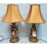 A pair of gilt-metal mounted porcelain lamps, with hand-painted floral decoration to sides and