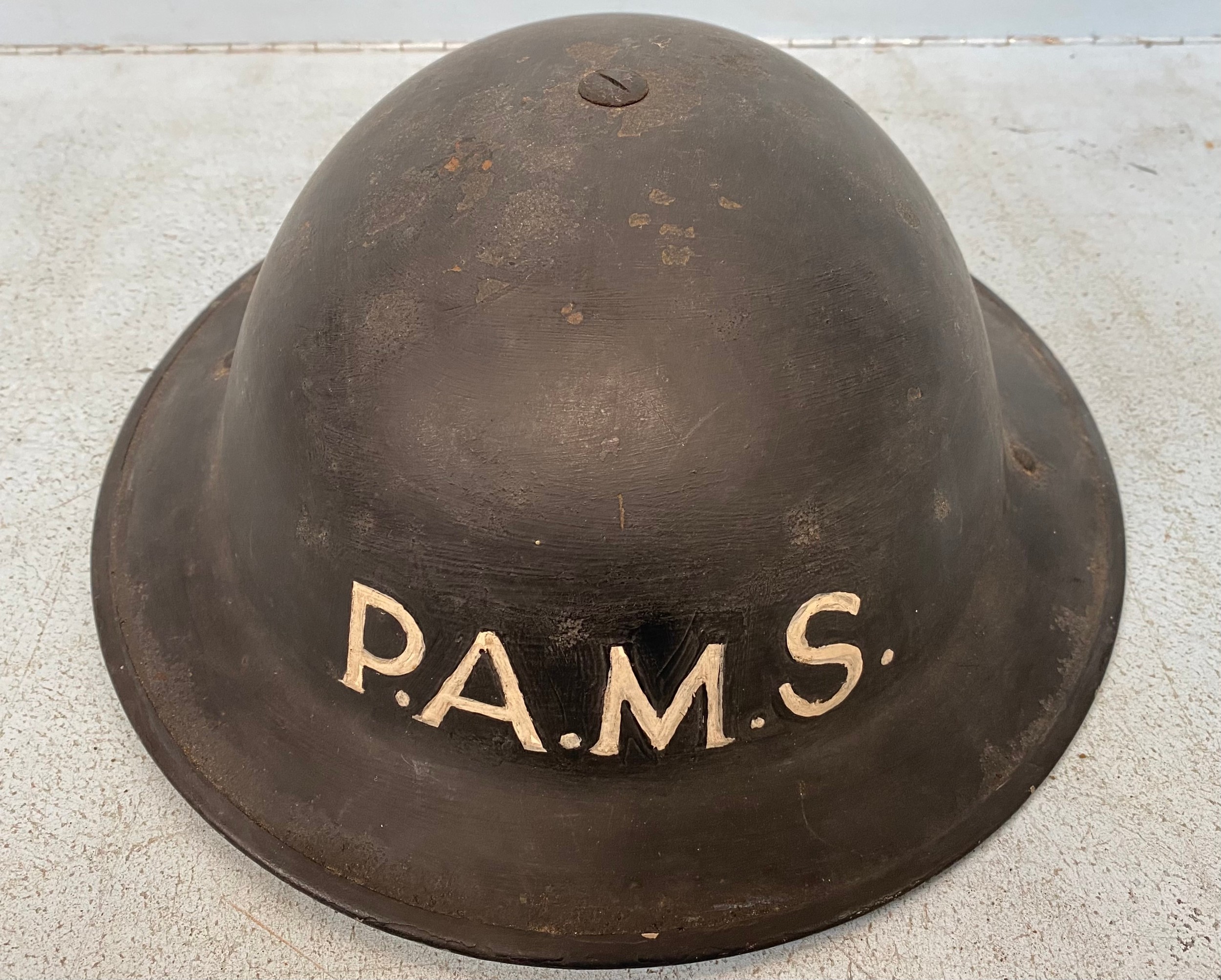 A WW2 Police Auxiliary Messenger Service helmet, black painted with letters