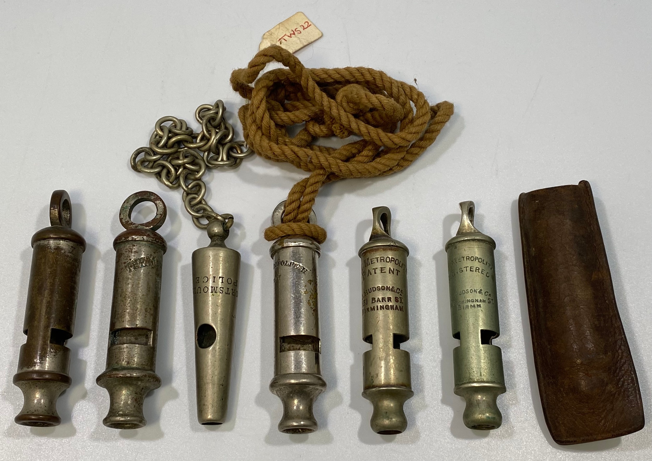 Six various whistles including 'Portsmouth Police' and 5x Metropolitans, one leather pouch (6)