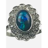 A platinum dress ring, set with an oval shaped dark blue opal to the centre, measuring approximately