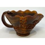 A Chinese carved horn libation cup, carved with foliage, 7cm high