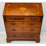 A George III mahogany and veneered bureau with sloped front above four long graduated drawers,