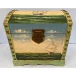 A dome-top wooden chest painted to the top and front with a ship in full sail