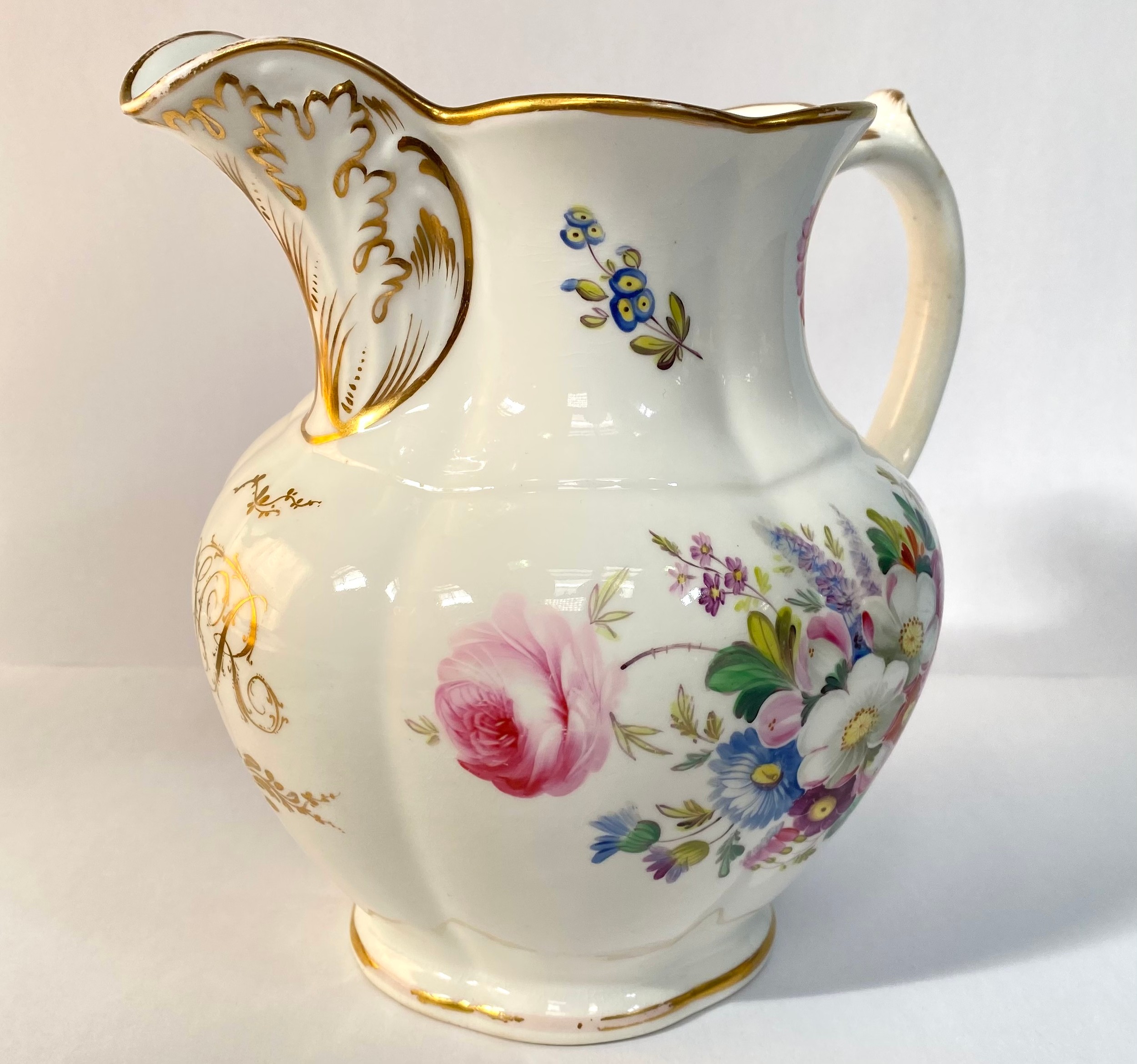 A 19th century porcelain jug, painted with flowers and with a gilt monogram 'VR', 19cm high, - Image 2 of 6