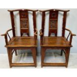 A pair of early 20th century stained elm Chinese carver chairs, with pierced and carved back,