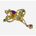 A 9ct yellow gold pendant/brooch, set with an oval red faceted stone to the centre, and a small